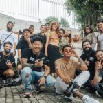Diverse group of friends having fun and posing for a group photo outdoors in São Paulo.